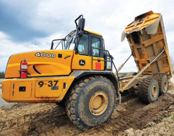 Heavy equipment operators and engineers aid in flood fight