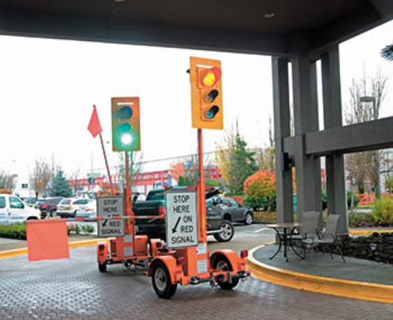 Portable traffic signal features gate arm