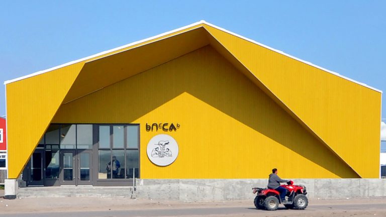 Pre-painted wood planks along with steel panels were used for the exterior cladding at the new cultural centre in the Northern Village of Kuujjuaraapik in Nunavik. Materials and building components were shipped to the site.