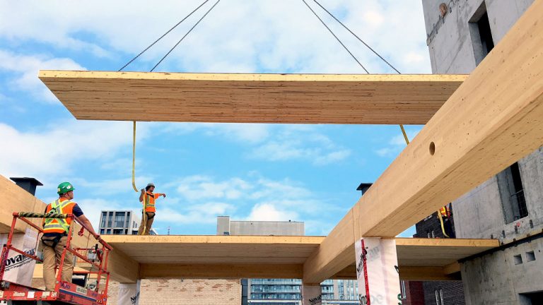 A nail-laminated timber panel is hoisted into place at the 80 Atlantic Ave. site in Toronto’s Liberty Village. Installation of the panels is scheduled for completion in early December. The project is the first new timber-frame commercial building to be constructed in the city in a generation.