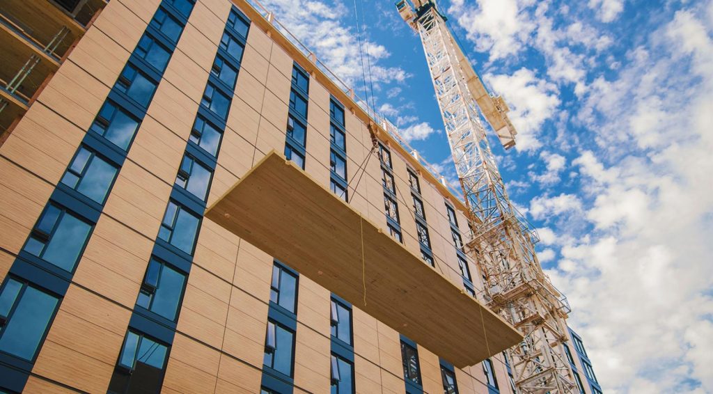 Crews lift wood panels onto Brock Commons at the University of British Columbia. The province recently announced a push to grow its mass timber industry.