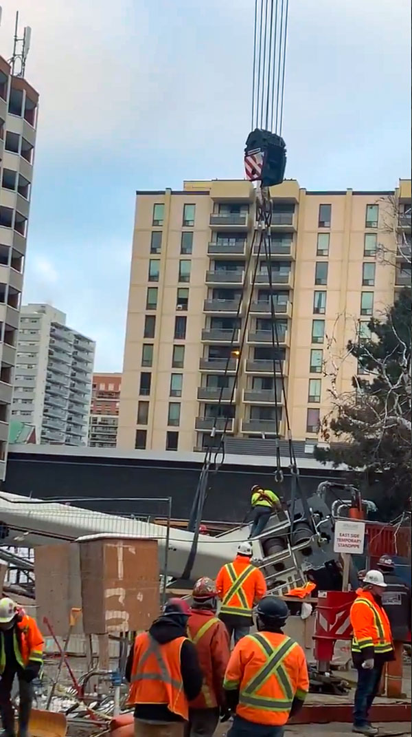 Twitter video shows crews lifting a disabled crane out of a sinkhole at an Eglinton Crosstown site at Eglinton and Mount Pleasant in Toronto.