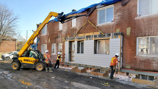 The answer to the challenge of an aging and energy inefficient housing stock is the erection of prefabricated energy-efficient panels, suggested Mark Carver, who heads Natural Resources Canada’s Prefabricated Exterior Energy Retrofit project. Pictured are walls being put up at an Ottawa Community Housing project.