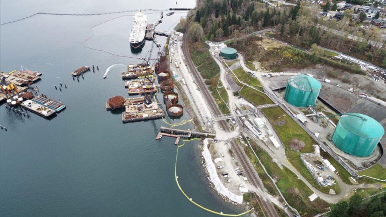 An aerial photograph shows work on the Westridge Marine Terminal in B.C. for the Trans Mountain Pipeline Expansion project. A report from the Canada Energy Regulator revealed that recent inspections showed some workers were not following COVID-19 protocols.