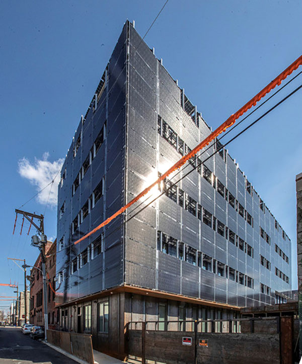 The Front Flats development in downtown Philadelphia, designed by the Onion Flats firm, may provide a glimpse of future multi-storey buildings that aim for true net zero energy status. The four-storey, 28-unit apartment building is wrapped on all sides with 492 translucent solar panels mounted two feet from the building’s airtight envelope. 