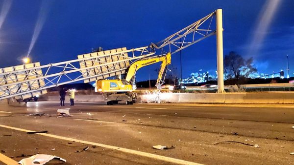 An excavator struck an overhead sign on the QEW in Burlington, Ont. early this morning (April 27) causing it to fall onto the highway and kill the motorist inside a passing vehicle. Police report the equipment was being driven by an operator enroute to a jobsite hauling a piece of equipment when the incident occurred.