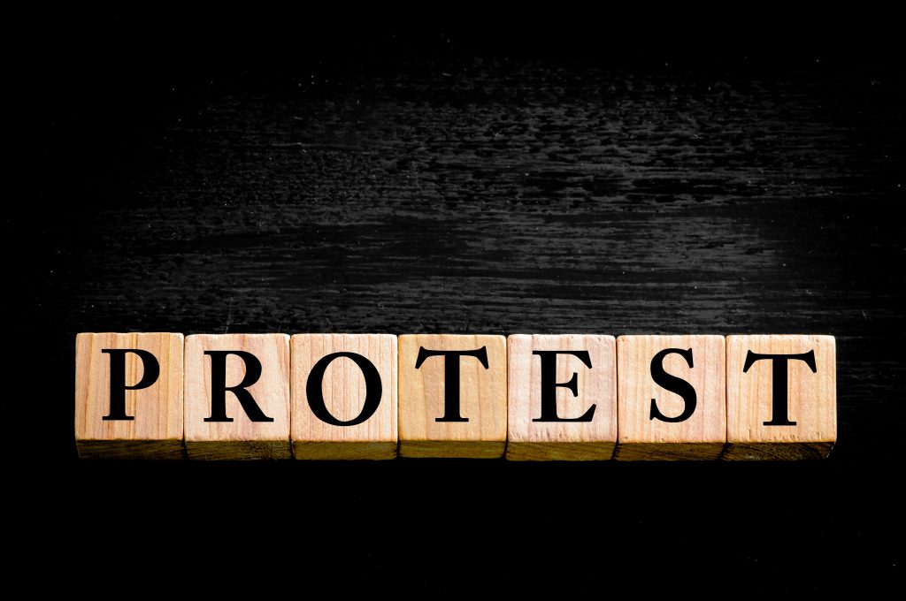 word-protest-wooden-small-cubes-with-letters-isolated-on-black