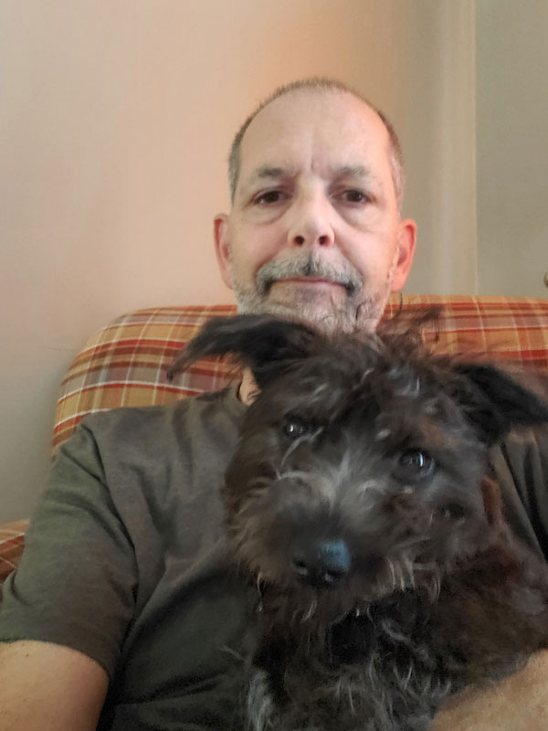 Smart Local 47 executive and mental health advocate Stuart Simpson encourages self-care, which in his case means spending time with family and friends and his three dogs, including Merlin (pictured).