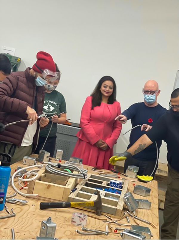 Supneet Chawla, founder and CEO of ACE Community College in Surrey, assists some of her trades students.