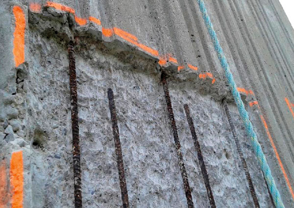 Using a swing stage, crews carefully removed chipped concrete to prepare for the restoration and coating. These images show the underlying rebar in one of the large slabs that make up the towers’ shear walls.