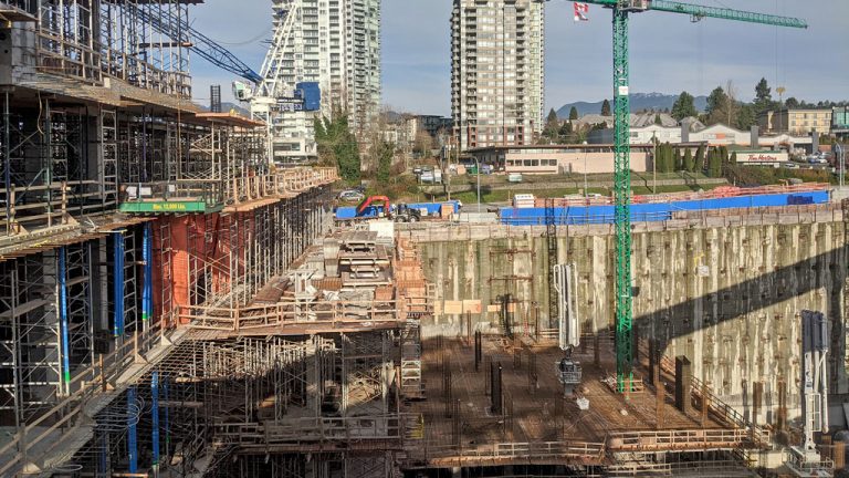 Crews work on the site of what will by Metro Vancouver's tallest residential tower. The Gilmore Place site also is being built around the active Gilmore SkyTrain station in coordination with TransLink.