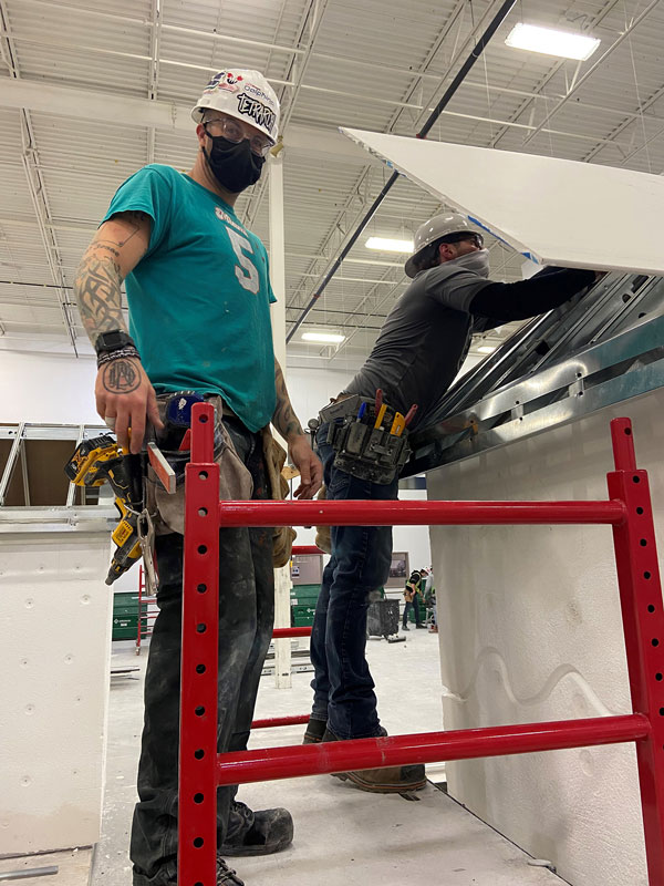 Casey Dewitt (left) and Daniel Frankiw are pictured taking part in the drywall acoustic apprenticeship at the Interior Finishing Systems Training Centre.