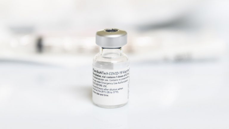 A vial of COVID-19 vaccine waits to be used. A panel of experts hosted by the Vancouver Regional Construction Association discussed whether companies should consider mandating vaccination and what considerations must be made.