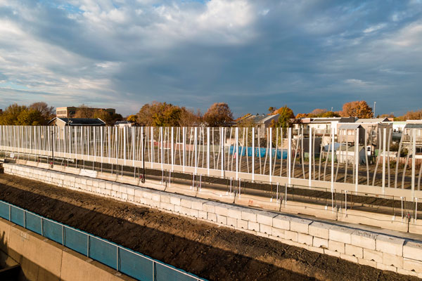 Pictured is a partially completed noise barrier and multi-use path outside the tunnel.