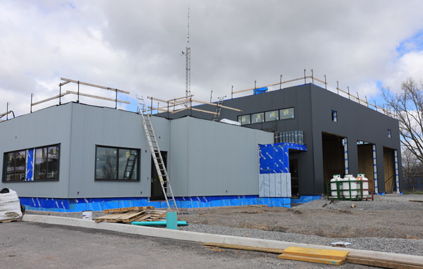 Exterior view of Fire Station #2 under construction with the single-storey admin wing and seven-metre-high apparatus bay in view.