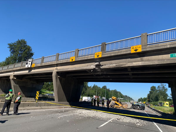 Two people were injured in the 192nd Street overpass incident. One lane of Highway 1 reopened 13.5 hours later.