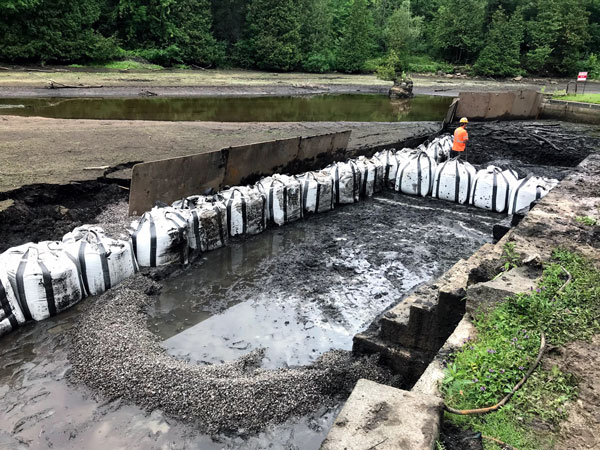R&M Construction (general contractor) removes sediment after the pond is drawn down, and begins to establish the temporary bypass channel along the north side of the headpond.