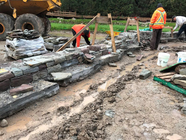 Dean McLellan Stonework and crew begin constructing the dry stacked low stone wall, a new landscape feature located in the heritage gardens area of Belfountain Conservation Area in the location of the former headpond.