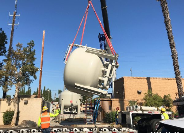 Pictured is a crane lifting a filtering tank into place at the Energy Field treatment plant.