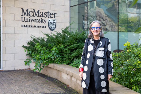 Professor Annemarie Adams is seen standing front of the McMaster Health Sciences Centre. She was the keynote speaker recently at the inaugural Architecture of Health: The Annual Zeidler-Evans Lecture series.