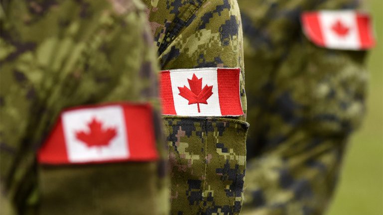 a close up of a Canadian flag patch on the arm of a soldier.