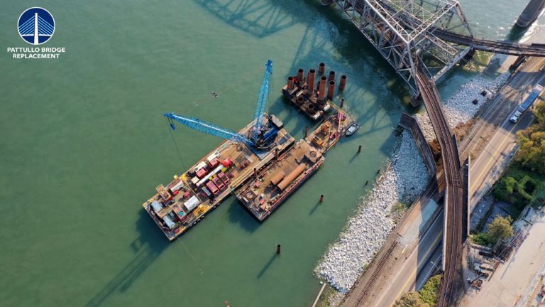 Barges floating on the Fraser River are used to install piles for the new Pattullo Bridge’s in-river piers.
