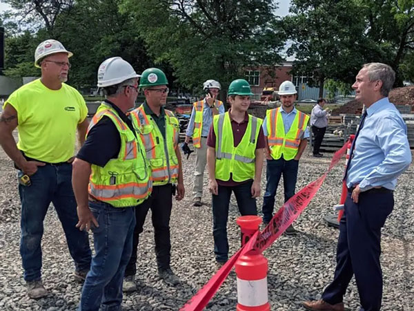 Senator Sean Ryan meeting with construction workers.