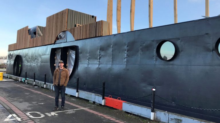 Pictured is Nicholas Van Buren in front of his property HAVN, a barge shapeshifting into saunas and hot and cold pools currently docked at Victoria’s Ogden Point.