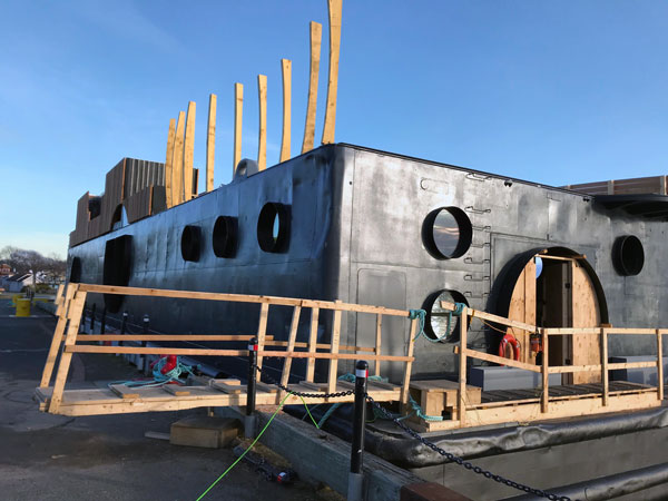 The U.S. barge from the Second World War has been cut, welded, primed, painted in preparation for a summer opening where customers can enjoy three saunas on the upper level.