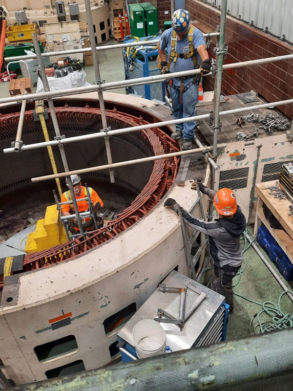 Scaffolders have to climb down 40 feet inside a dam as part of their duties on the Tobique Narrows Generating Station rehabilitation project in New Brunswick.