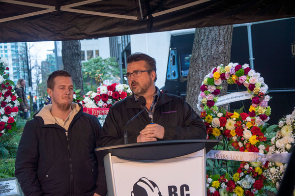 Mike Davis and his son Jacob Davis. Mike is the son of Donald Davis, one of the carpenters who died in the Bentall tragedy in 1981. “Please don’t let this happen to anyone again,” Davis says to the crowd gathered at the memorial in downtown Vancouver.
