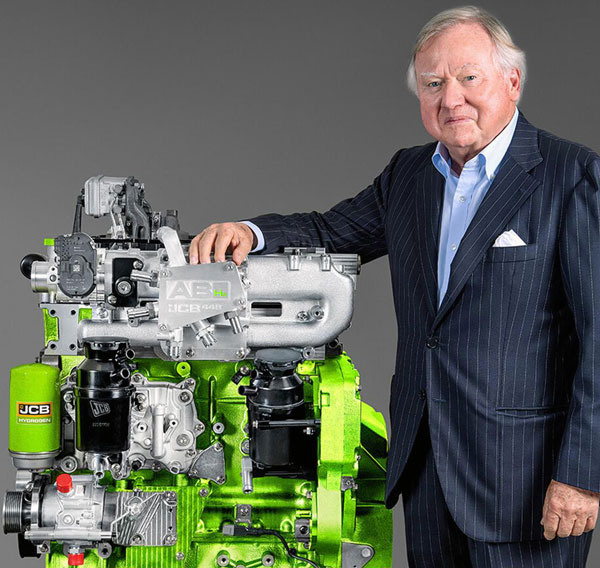 Lord Bamford, chairman and managing director of JCB Excavators Ltd., stands with the company’s new hydrogen-powered engine.
