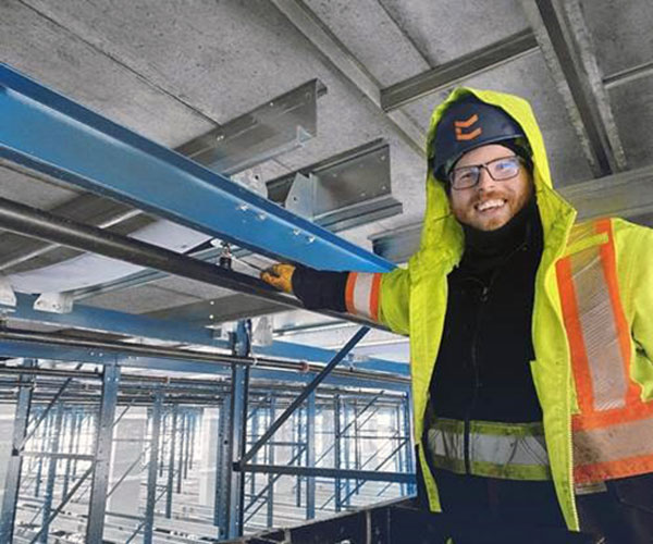 Classic Fire + Life Safety is holding a hiring fair to find skilled workers to work on the new NextStar Energy EV battery plant in Windsor, Ont. Pictured is a Classic sprinkler fitter installing in-rack sprinkler systems.
