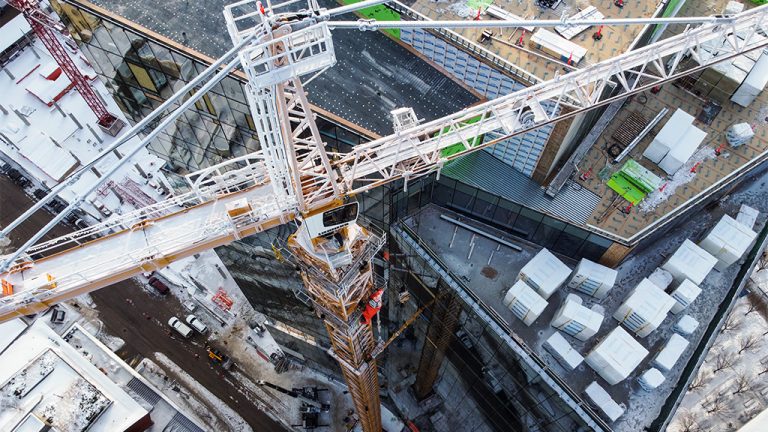 PCL Constructors Canada Inc. used its largest ever freestanding crane to build the Wawanesa Insurance Tower in Winnipeg. The hammerhead crane stood 93.1 metres and had an enormous concrete base to keep it anchored.