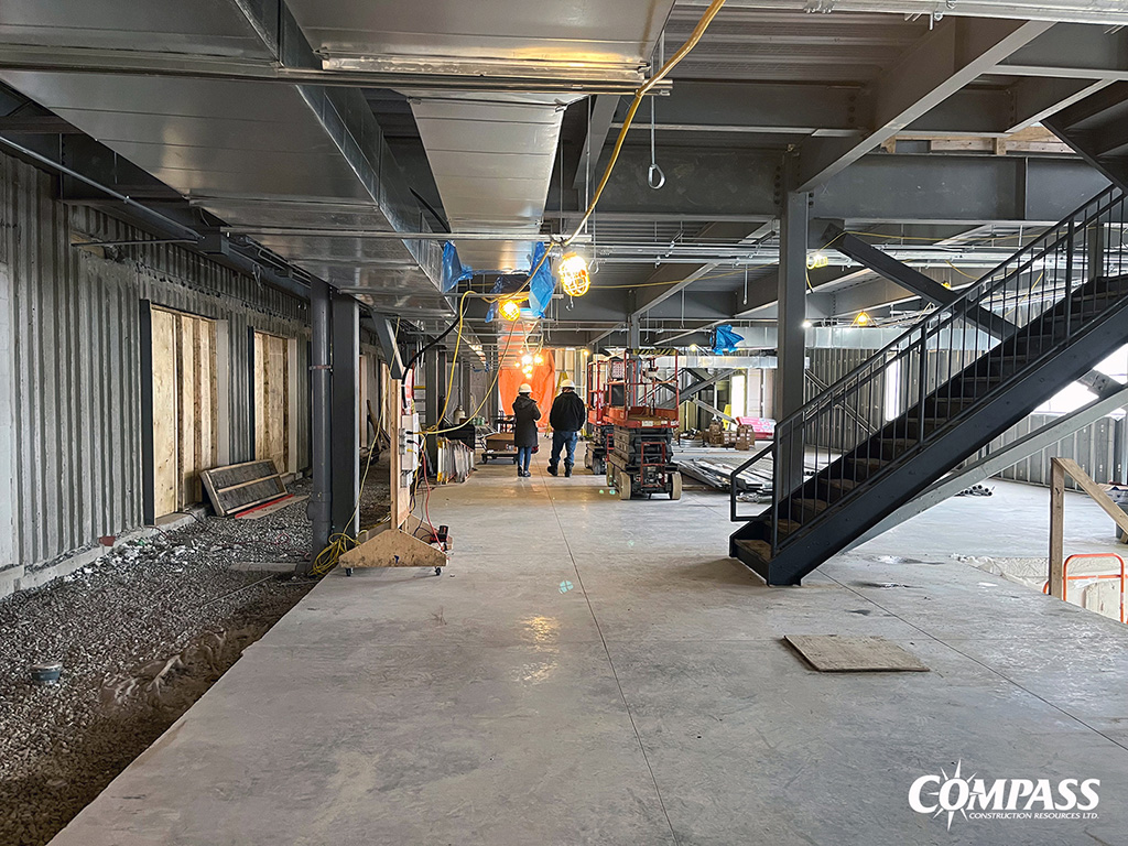 The main staircase, structural cross bracing and underground works for mechanical services are underway and the crew is preparing the floor for a cement pour, where the building addition will interface with the existing slab-on-grade building.