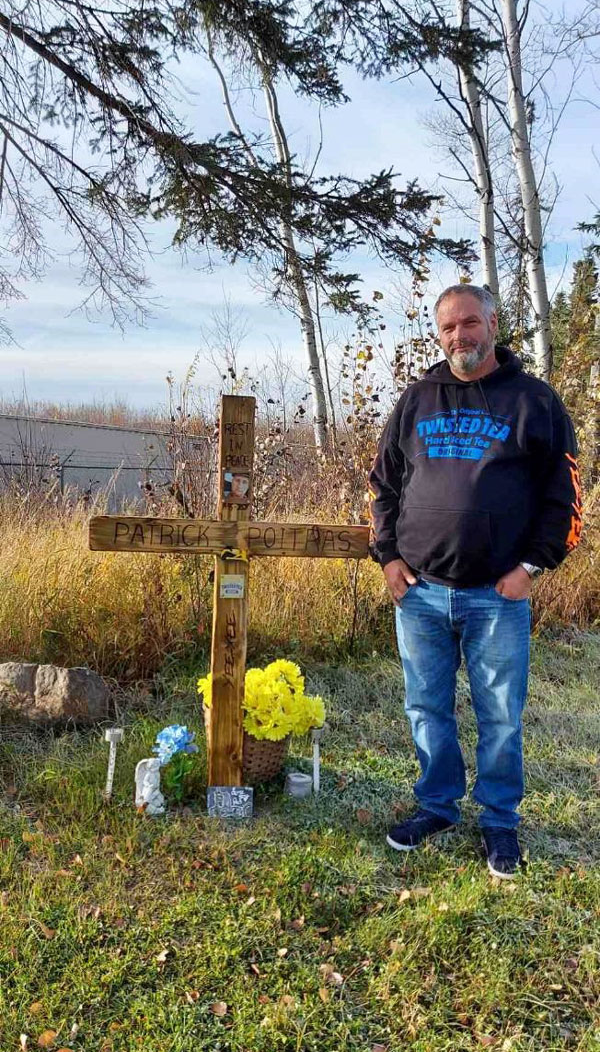 Marcel Poitras stands by his son Patrick’s grave in New Brunswick.