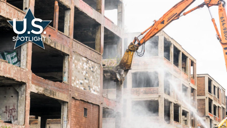 Pictured, an excavator has a go of it at the mammoth Detroit Packard plant.