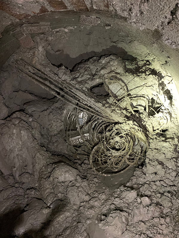 A City of Toronto photo shows steel tie-backs left over from a previous shoring job entangling a micro-tunnelling boring machine on Old Mill Drive.