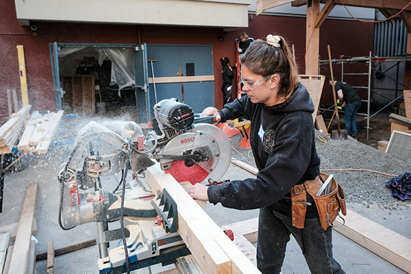 A volunteer skilled trades worker saws through a couple two-by-fours at HeroWork’s 2022 project at the Victoria Cool Aid Society’s Downtown Community Centre. Kate Markham-Zantvoort, trade and supply co-ordinator with HeroWork, says more than 700 people volunteered for the project.