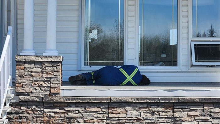 Mike Burstin catches some much-needed rest on the front porch between a 26-30 hour firefighting shift in south Entwistle.