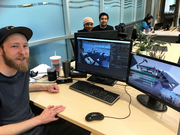 Master’s student Todd Charter and his virtual reality-created classroom and assembly lines, with fellow researchers Ogunfowora Oluwaseyi, masters and Maziyar Khadivi, PhD.