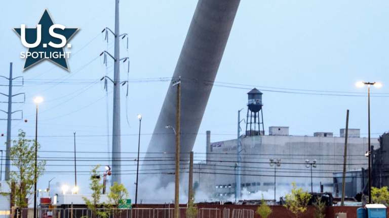 The Detroit incinerator's 333-foot stack falls westerly away from neighborhoods in an early morning implosion.