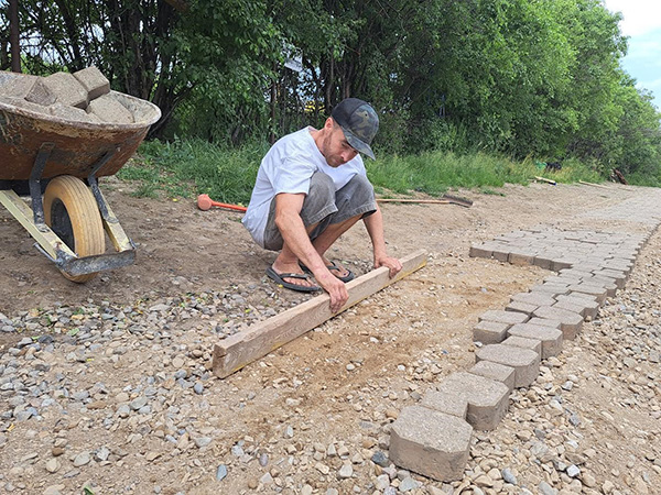 Residents who live in the community contribute in different ways. Recently, they helped install a walkway on the back street of the property.