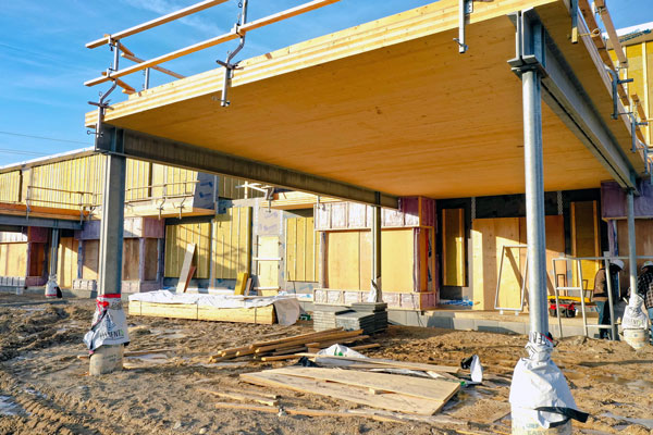 The 781-square-metre building features cross-laminated timber (CLT) and glulam as the superstructure and cross laminated insulated panels as the envelope. Shown here is the CLT portico and outdoor play area.