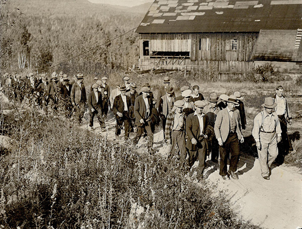 Grim relief workers trek to Klock, a village east of Mattawa, Ont., in 1931 for roadwork. Klock has since been abandoned.