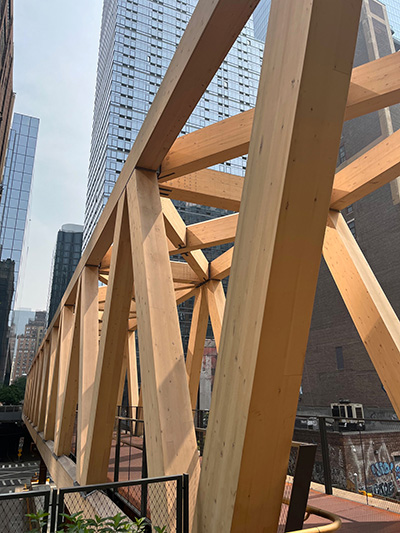 For the timber bridge, 16-by-24-inch CLT vertical diagonals were used. The top and bottom chords were spliced together with a cross section spanning 16-by-28 inches, and are between 85 feet and 110 feet in length.