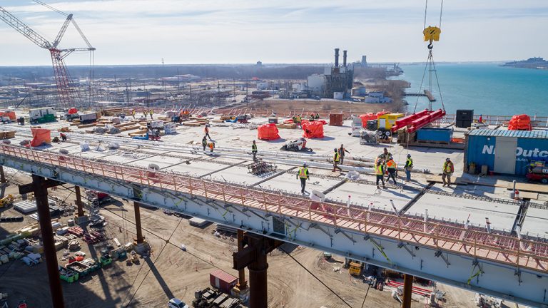 Pictured is the back span on the Canadian side of the Gordie Howe International Bridge with falsework beneath, part of the “unbalanced” cantilevered construction method.