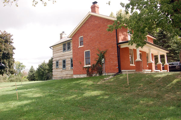 The original red brick appearance on the west wing was recaptured by turning the painted bricks around, while the large thick logs on the east half were left exposed.