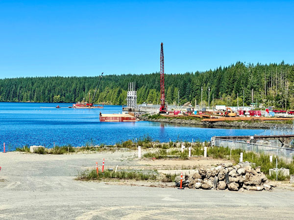 Shown is a barge in the reservoir at the John Hart Dam placing piles.