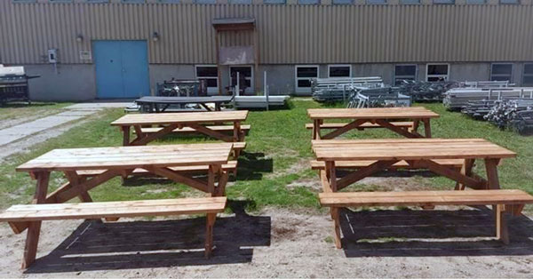 Shown are wood picnic tables, projects made by the inmates in the course.